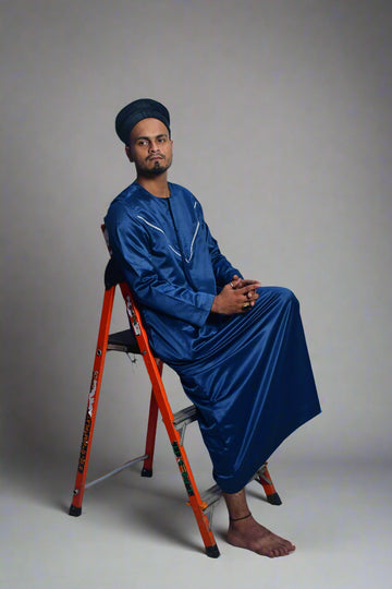 Person in blue outfit with orange crutches on a white background