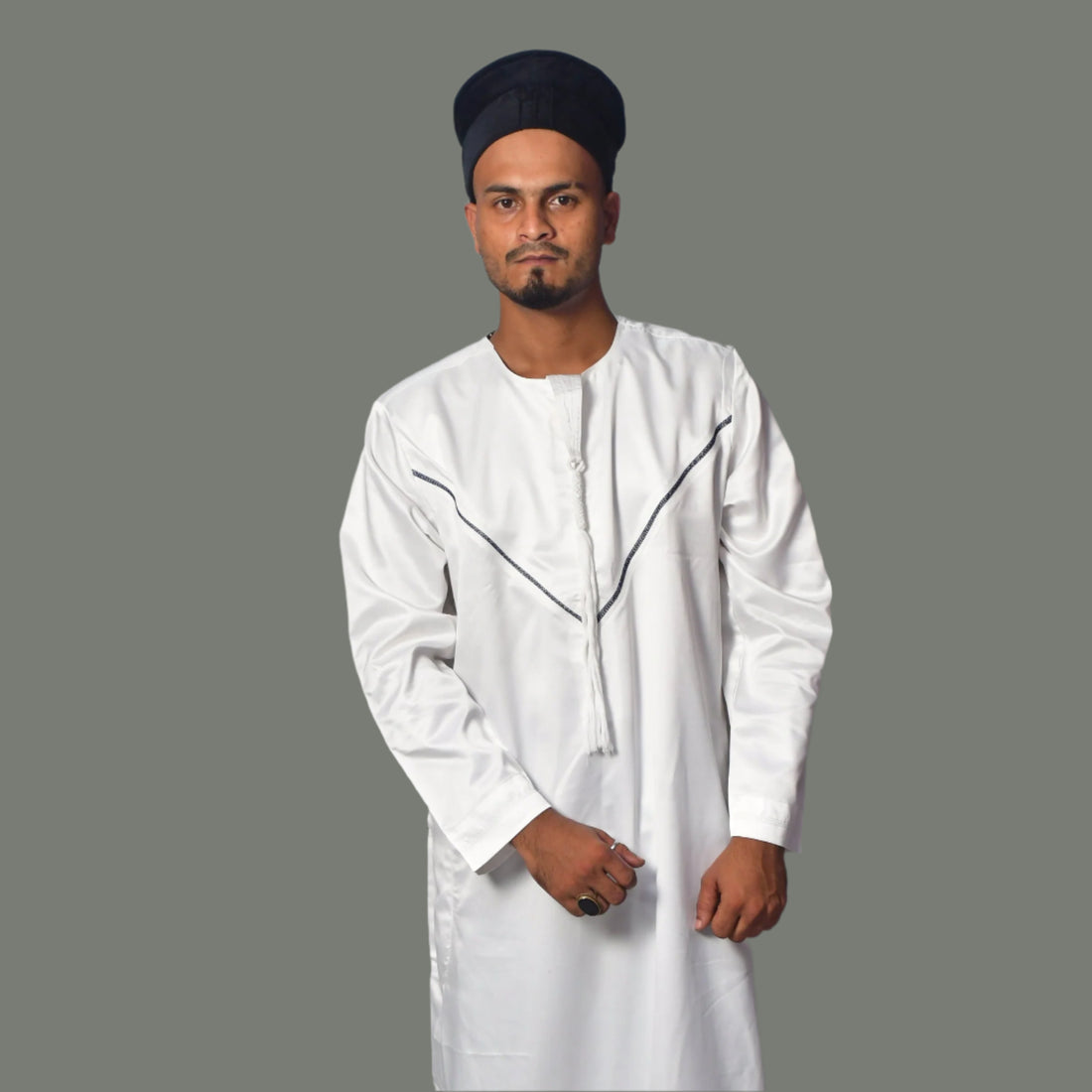 Person wearing a white traditional outfit against a plain background