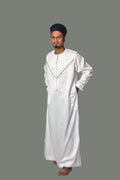 Person wearing a white traditional outfit against a plain background