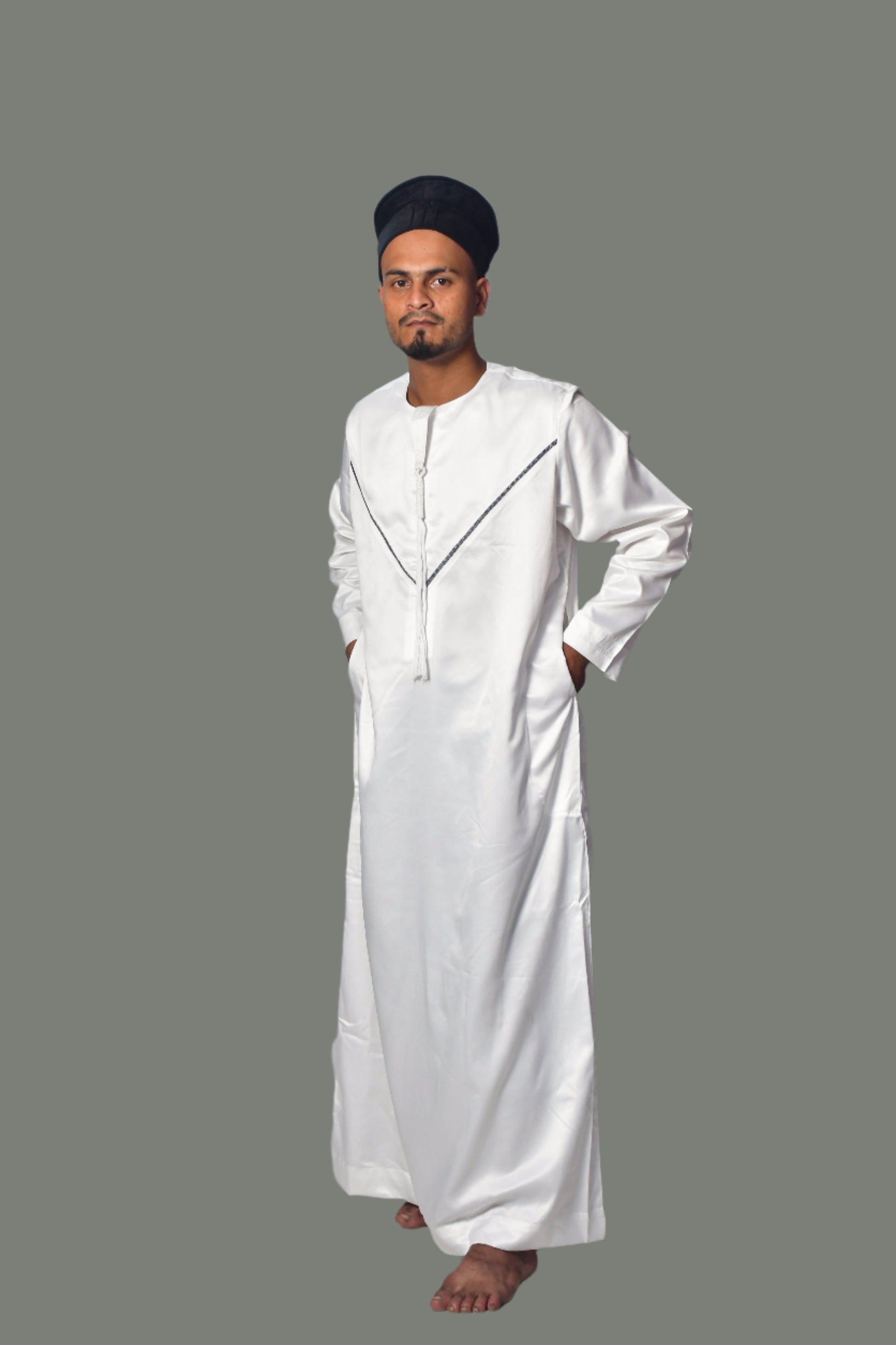 Person wearing a white traditional outfit against a plain background