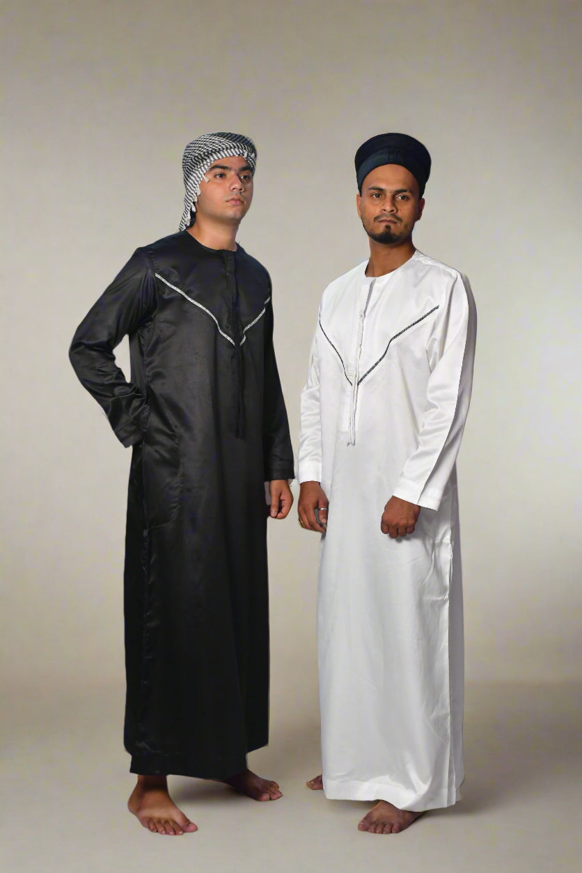 Two individuals wearing black and white traditional outfits on a white background