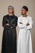 Two people wearing black and white outfits on a white background