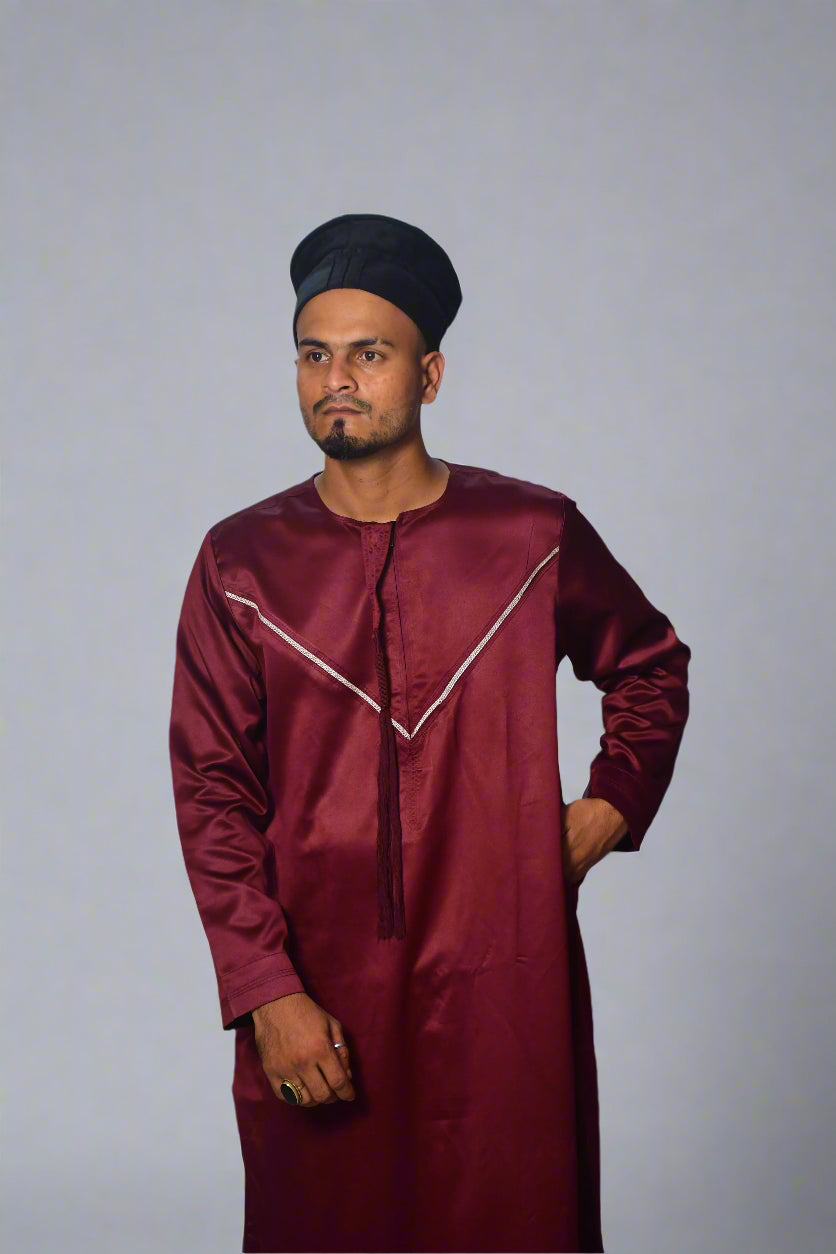 Man wearing a maroon traditional outfit with a white background
